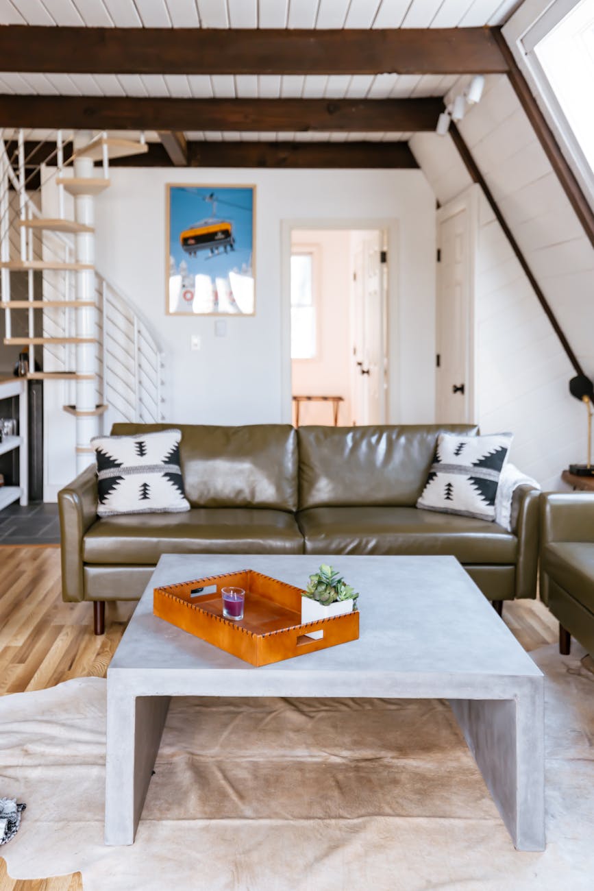 a living room with a couch coffee table and a ladder